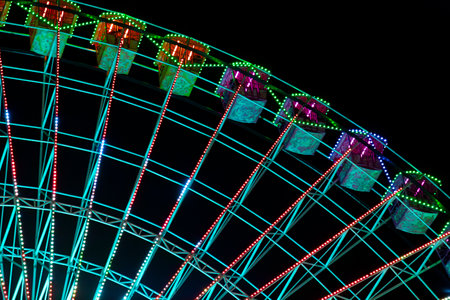 Ferris wheel. Noria. Christmas lights in Vigo, Pontevedra. Christmas decorations. Tourists strolling through its streets. Ferris wheel in the dark showing neon colors. VIGO. SPAIN.の写真素材