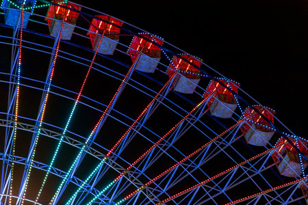 Ferris wheel. Noria. Christmas lights in Vigo, Pontevedra. Christmas decorations. Tourists strolling through its streets. Ferris wheel in the dark showing neon colors. VIGO. SPAIN.の写真素材