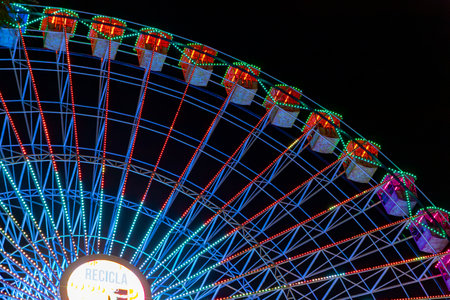 Ferris wheel. Noria. Christmas lights in Vigo, Pontevedra. Christmas decorations. Tourists strolling through its streets. Ferris wheel in the dark showing neon colors.の写真素材