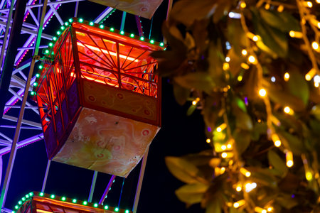 Ferris wheel. Noria. Christmas lights in Vigo, Pontevedra. Christmas decorations. Tourists strolling through its streets. Ferris wheel in the dark showing neon colors.の写真素材