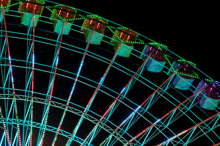 Ferris wheel. Noria. Christmas lights in Vigo, Pontevedra. Christmas decorations. Tourists strolling through its streets. Ferris wheel in the dark showing neon colors. VIGO. SPAIN.の写真素材