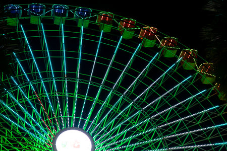 Ferris wheel. Noria. Christmas lights in Vigo, Pontevedra. Christmas decorations. Tourists strolling through its streets. Ferris wheel in the dark showing neon colors. VIGO. SPAIN.の写真素材