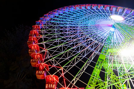 Ferris wheel. Noria. Christmas lights in Vigo, Pontevedra. Christmas decorations. Tourists strolling through its streets. Ferris wheel in the dark showing neon colors. VIGO. SPAIN.の写真素材