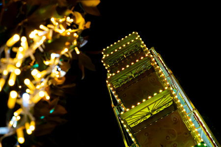 Ferris wheel. Noria. Christmas lights in Vigo, Pontevedra. Christmas decorations. Tourists strolling through its streets. Ferris wheel in the dark showing neon colors. VIGO. SPAIN.の写真素材
