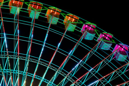 Ferris wheel. Noria. Christmas lights in Vigo, Pontevedra. Christmas decorations. Tourists strolling through its streets. Ferris wheel in the dark showing neon colors.の写真素材