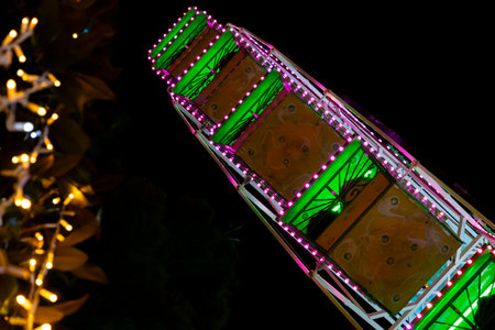 Ferris wheel. Noria. Christmas lights in Vigo, Pontevedra. Christmas decorations. Tourists strolling through its streets. Ferris wheel in the dark showing neon colors. VIGO. SPAIN.の写真素材