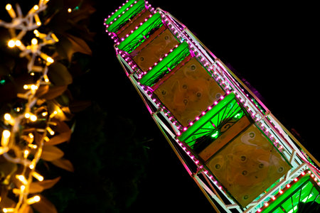 Ferris wheel. Noria. Christmas lights in Vigo, Pontevedra. Christmas decorations. Tourists strolling through its streets. Ferris wheel in the dark showing neon colors. VIGO. SPAIN.の写真素材
