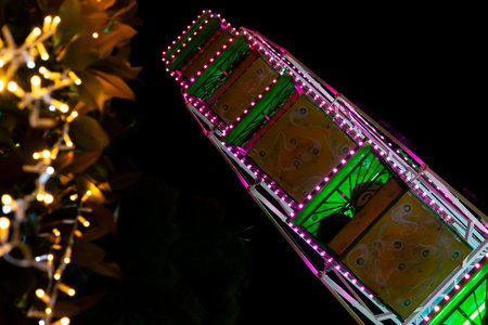 Ferris wheel. Noria. Christmas lights in Vigo, Pontevedra. Christmas decorations. Tourists strolling through its streets. Ferris wheel in the dark showing neon colors. VIGO. SPAIN.の写真素材