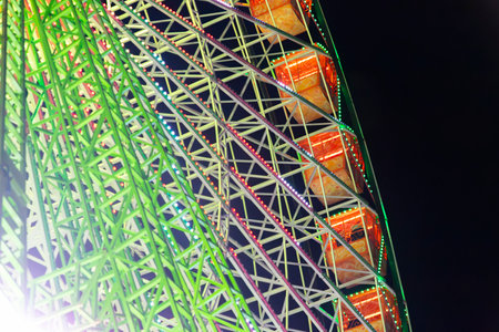 Ferris wheel. Noria. Christmas lights in Vigo, Pontevedra. Christmas decorations. Tourists strolling through its streets. Ferris wheel in the dark showing neon colors.の写真素材