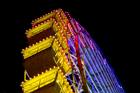 Ferris wheel. Noria. Christmas lights in Vigo, Pontevedra. Christmas decorations. Tourists strolling through its streets. Ferris wheel in the dark showing neon colors. VIGO. SPAIN.の写真素材