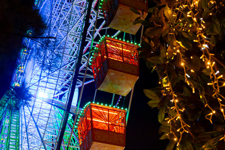 Ferris wheel. Noria. Christmas lights in Vigo, Pontevedra. Christmas decorations. Tourists strolling through its streets. Ferris wheel in the dark showing neon colors. VIGO. SPAIN.の写真素材