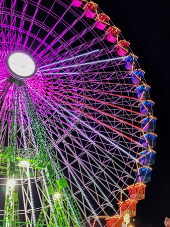 Ferris wheel. Noria. Christmas lights in Vigo, Pontevedra. Christmas decorations. Tourists strolling through its streets. Ferris wheel in the dark showing neon colors. VIGO. SPAIN.の写真素材