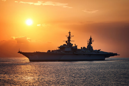 Aircraft carrier on sea near Iraq over sunset. Conflict in the Middle East. War between Iran and Israel with the participation of countries such as the United States and Russia.の写真素材