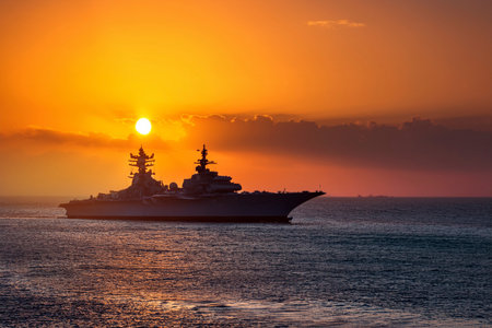 Aircraft carrier on sea over sunset.の写真素材