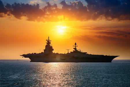 Aircraft carrier on sea near Iraq over sunset. Conflict in the Middle East. War between Iran and Israel with the participation of countries such as the United States and Russia.の写真素材