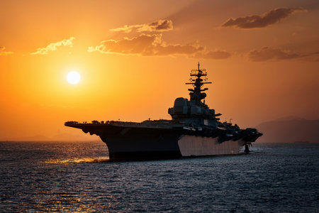 Aircraft carrier on sea over sunset.の写真素材