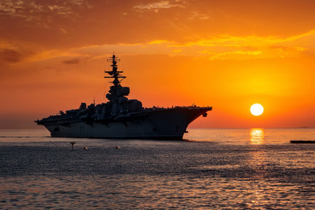 Aircraft carrier on sea near Iraq over sunset.の写真素材
