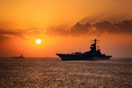 Aircraft carrier on sea over sunset.の写真素材