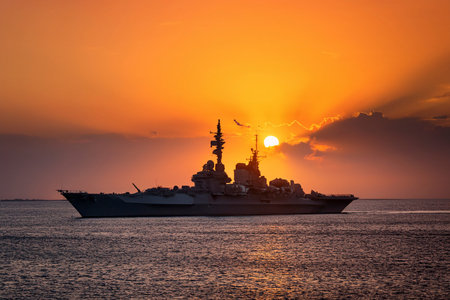 Aircraft carrier on sea over sunset.の写真素材