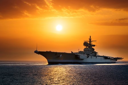 Aircraft carrier on sea near Iraq over sunset.の写真素材