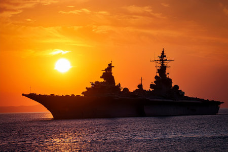 Aircraft carrier on sea near Iraq over sunset. Conflict in the Middle East. War between Iran and Israel with the participation of countries such as the United States and Russia.の写真素材