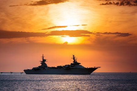 Aircraft carrier on sea over sunset.の写真素材