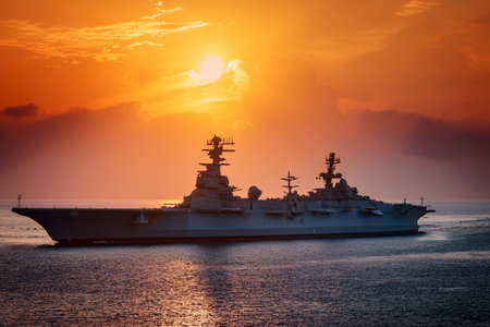 The Royal Australian Navy (USAF) guided-missile destroyer USS Midway at sunset.の写真素材