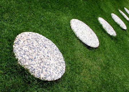 Selected round concrete precast placed on a bermuda grasses for stepsの写真素材