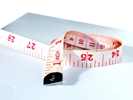 Measuring tape with White with red numbers with given inches and centimeters measurementsの写真素材