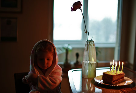 sad cute redhead girl during birthday with expresionally twisted hands