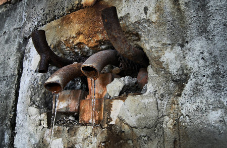 old piping at industrial decayed cite with frozen leakege