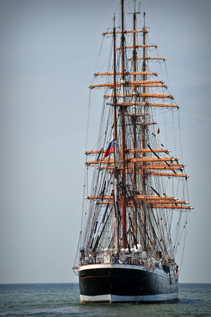 Aft of the sailboat leaving to the open sea