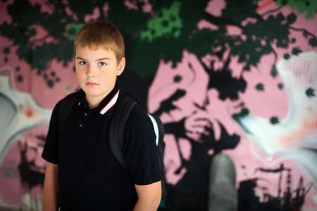 Teenage boy with skateboard against purple graffity wall check out more of the same seriesのeditorial素材