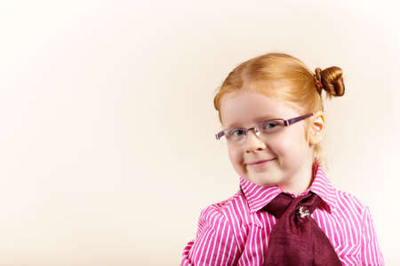 Girl redhead elegant with glasses against slightly purple background showing various facial expresions and copy paste spaceの写真素材