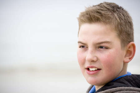 Teenager boy looking at camera in cold weather with sveater look for more o the same modelの写真素材