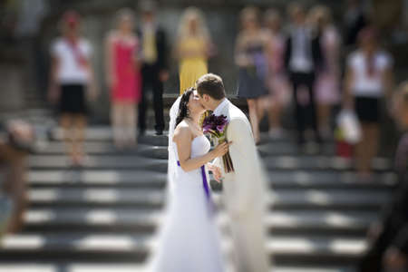 Groom and bride kissing on stairs soft focus filterの写真素材