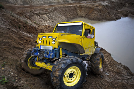 4x4 truck driving in sand quarry on scarp