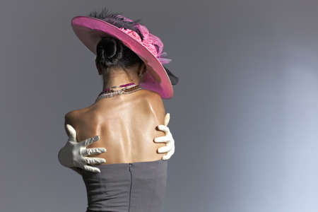 Young woman from behind vintage hat and styleの写真素材