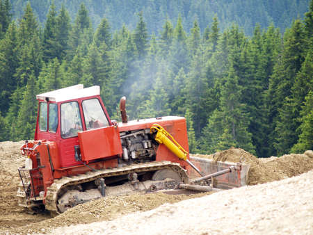 buldozer working in wooden mountains   の写真素材