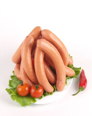 plate with fresh sausages decorated with vegetables    の写真素材