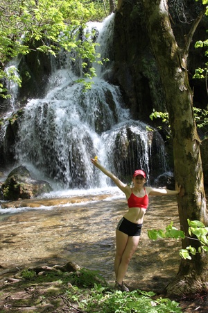 young woman posing  near waterfall during the springのeditorial素材