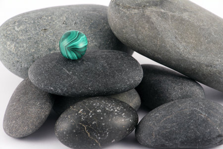 Black stones with green stoneの写真素材