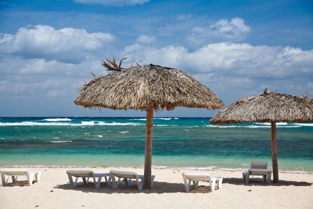 Caribbean tropical beach with straw umbrellaの写真素材
