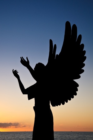 Silhouette of Angel of Hope against sunset sky, Puerto Vallarta, Mexicoの写真素材
