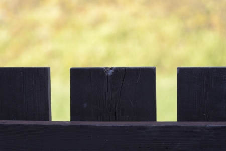 fence with dark wood and old flower backgroundの写真素材