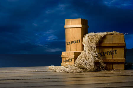 wooden crates on a dock at nightの写真素材