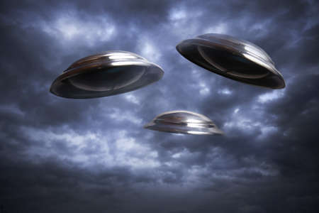 Photo of three UFO's flying in the skyの写真素材