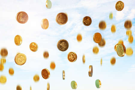 photo of golden coins raining from the skyの写真素材
