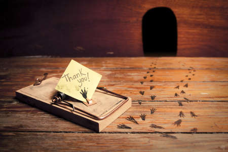 activated mousetrap with funny message instead of cheeseの写真素材