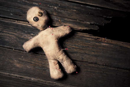 photo of creepy voodoo doll on wooden floorの写真素材
